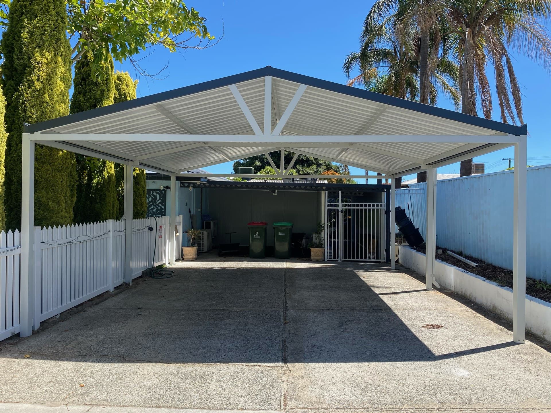 Gable carport with red ridge capping and exposed trusses in Perth