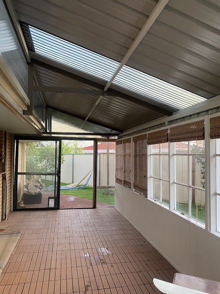 Enclosed gable patio with polycarbonate skylight and tiled floor at a Perth home