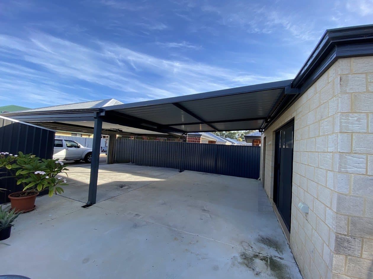 Skillion patio with dark steel frame over a paved courtyard beside a rendered stone Perth home
